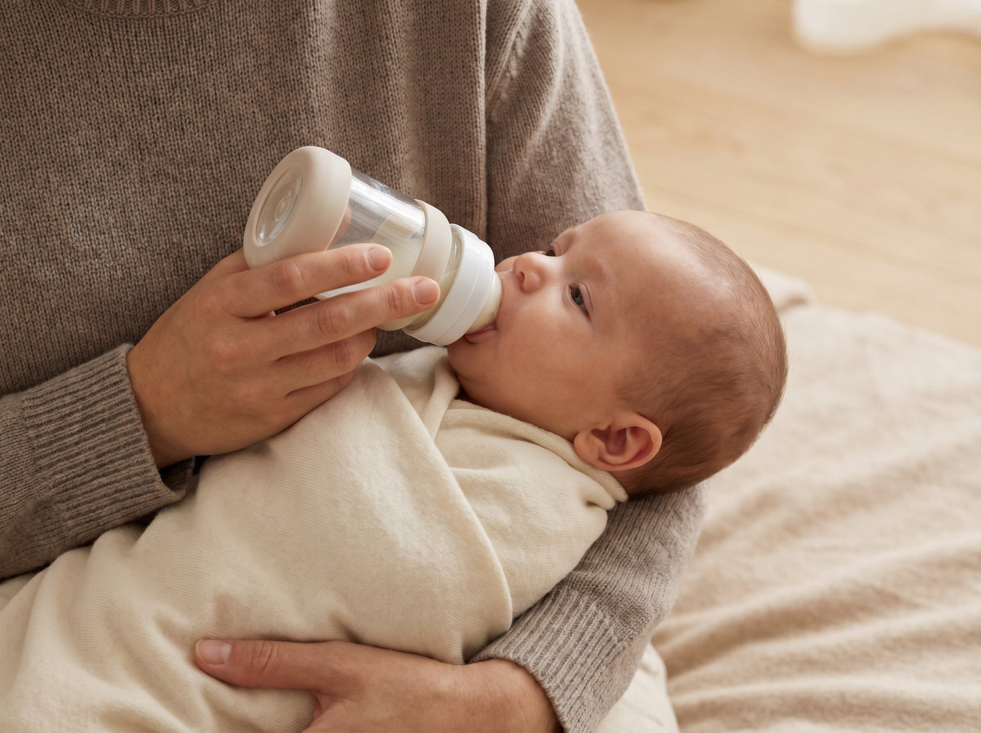Supportive 45-degree baby feeding angle posture using an anti-colic glass bottle to assist with daily infant comfort.
